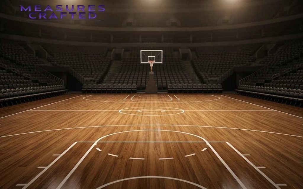 An aerial view of an empty basketball court, showing its full length of about 100 feet.